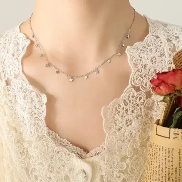 Woman's neck showing Stars necklace, silver color