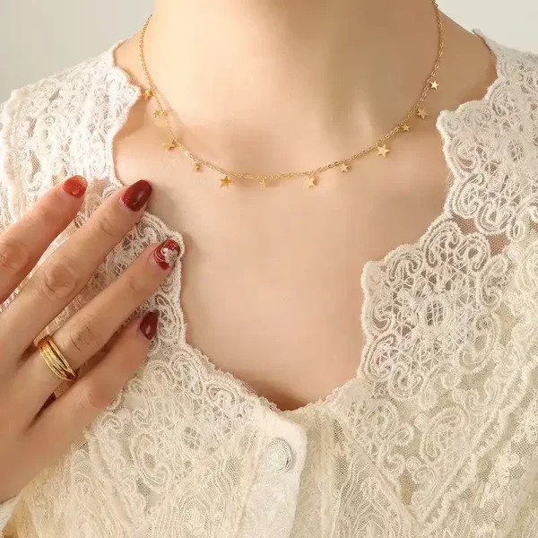 Woman's neck showing Stars necklace, gold color